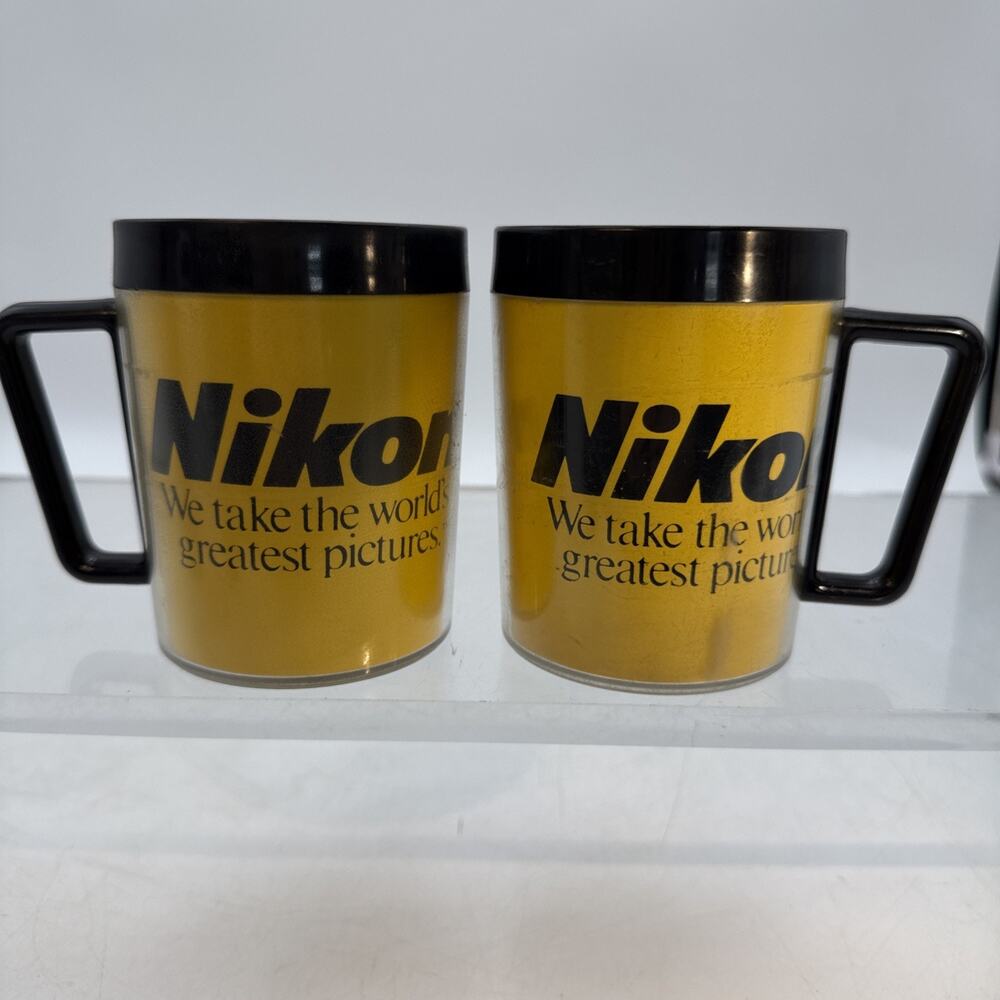 2 Vintage Nikon Mug Thermal Plastic Weighted Base Black Yellow Logo USA⬇️